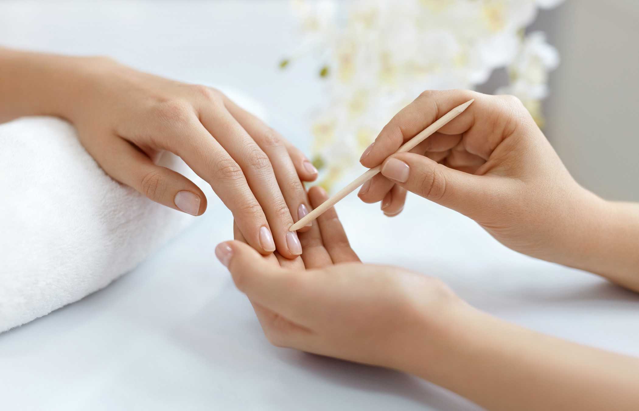 A woman receiving a manicure