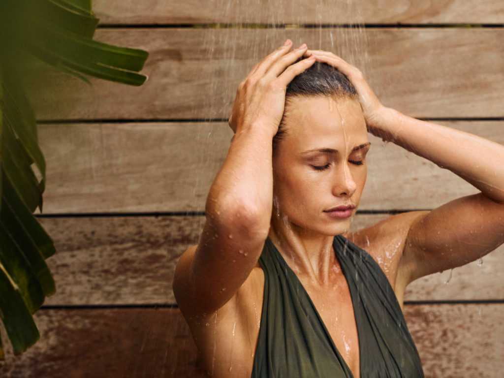 A woman relaxing in an outdoor shower