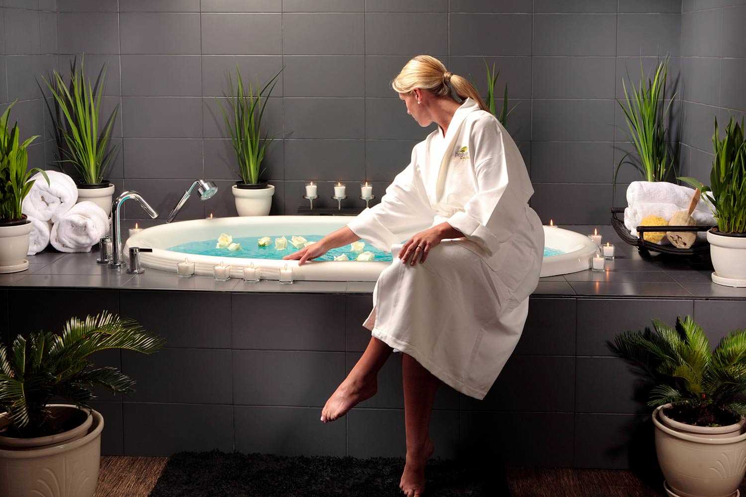 woman in a robe at spa bathtub