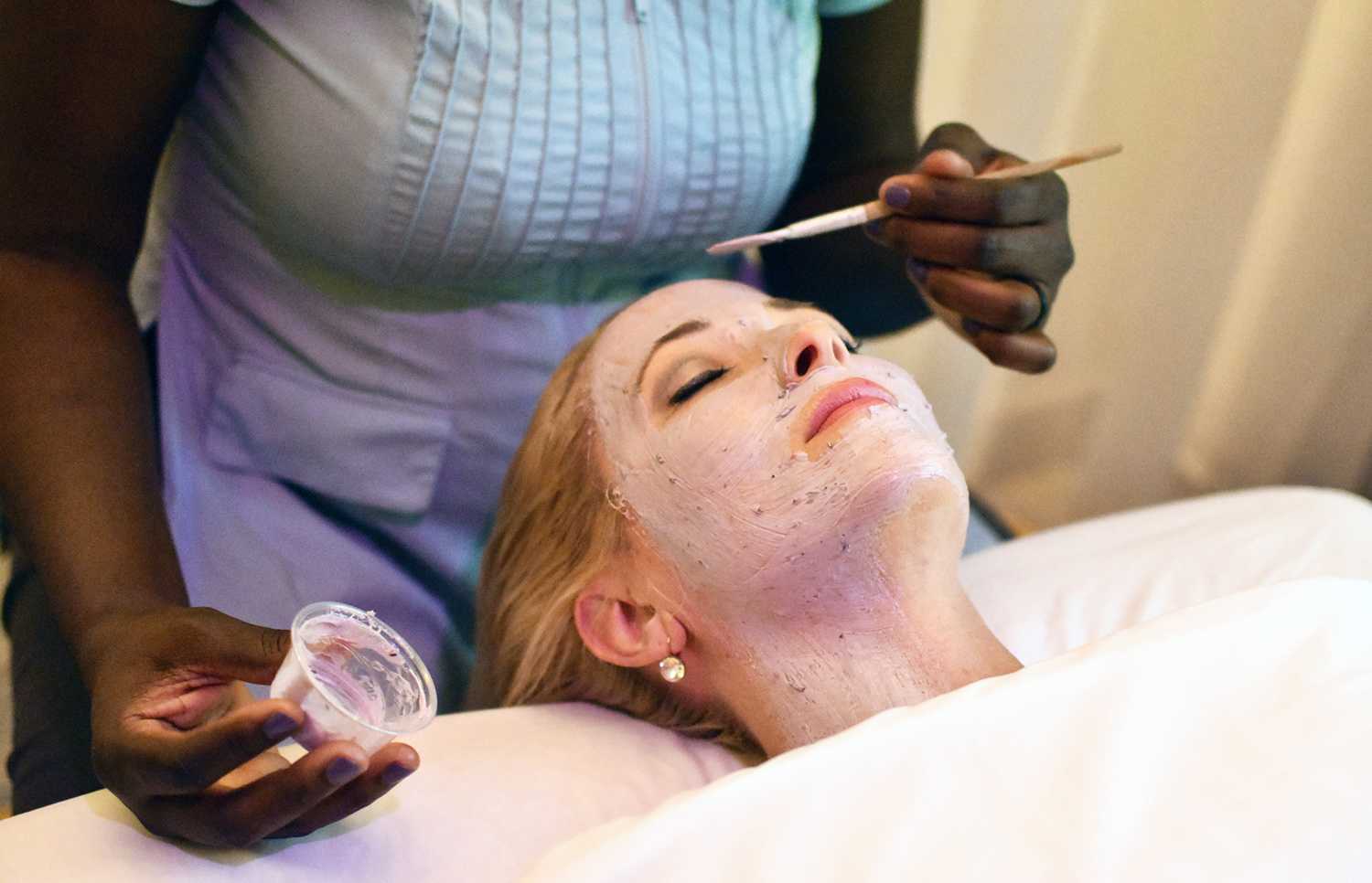 woman receiving a facial treatment at the spa